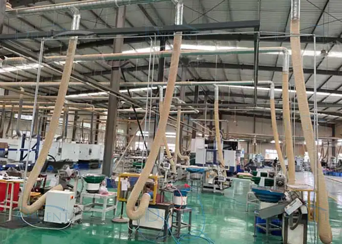 DECENT factory interior with multiple flexible dedusting hoses and machinery, demonstrating Qingdao Decent Group's air quality solutions