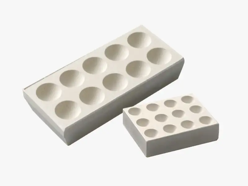 DECENT Magnesia Bullion Blocks for fire assay, showing two different sizes.