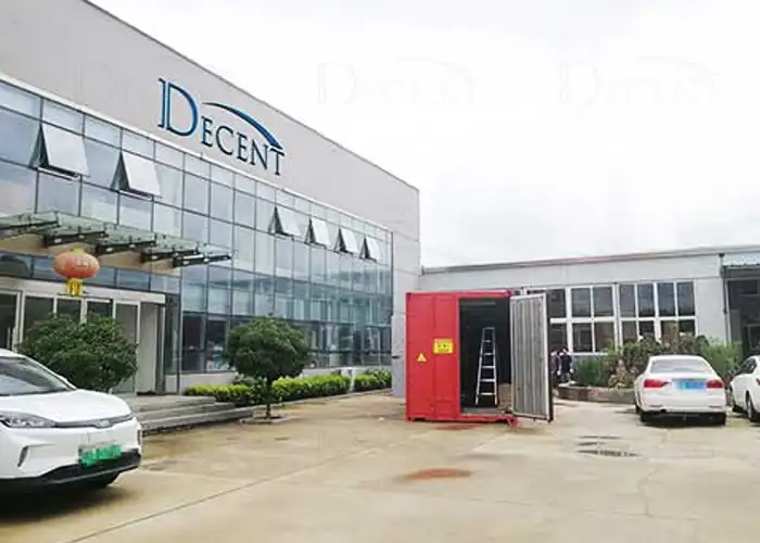 Qingdao Decent Group’s red containerized sampling & preparation lab outside its factory, integrating crushers and splitters for on-site ore processing.