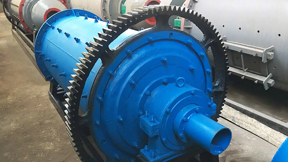 Close-up of the large gear and blue body of a industrial ball mill by Qingdao Decent Group