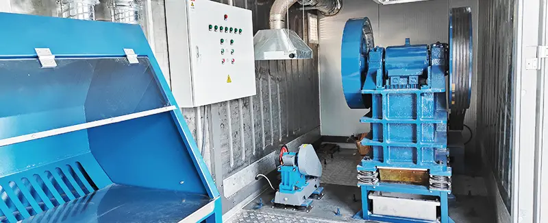 Industrial jaw crusher machine in a laboratory or processing facility, used for ore crushing, representing DECENT's sample preparation equipment