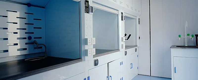 Modern laboratory with multiple fume hoods and safety features, illustrating DECENT's commitment to accident prevention