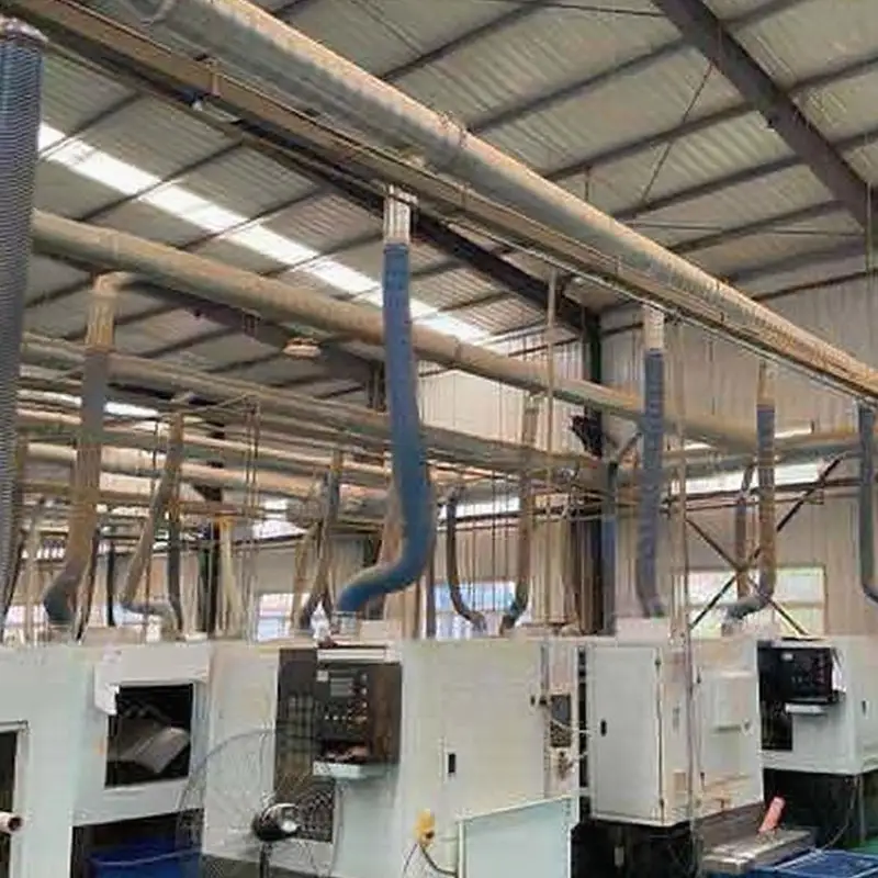 Factory interior with overhead dedusting system, blue ducts, and industrial machinery by Qingdao Decent Group