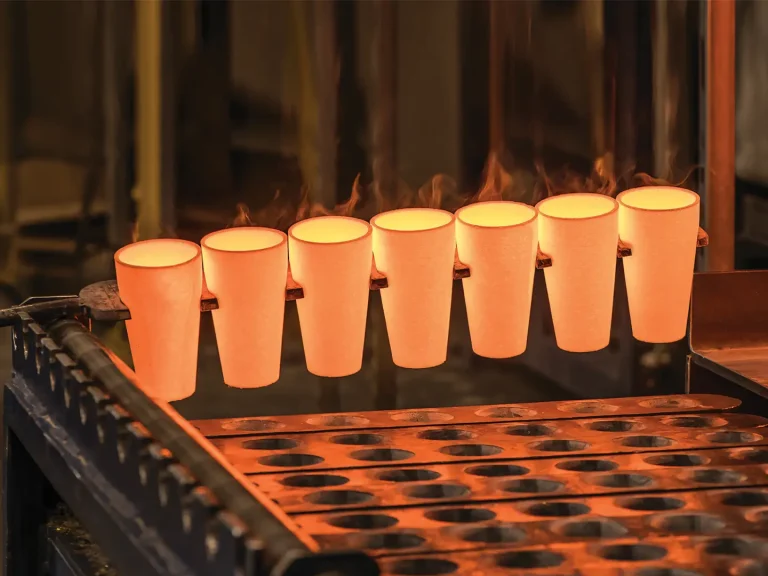 A row of glowing orange crucibles being processed in a high-temperature furnace, illustrating Qingdao Decent Group's fire assay capabilities.