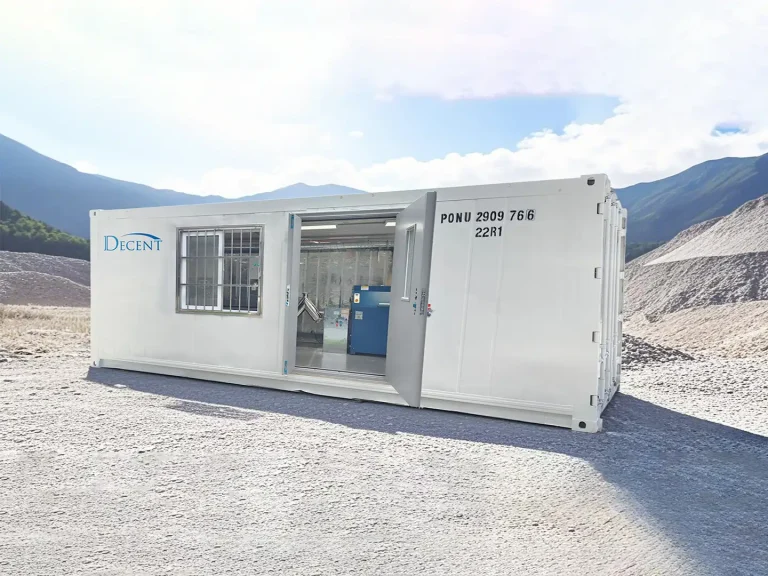 A white mobile containerized laboratory with the DECENT logo, situated in a rugged, mountainous outdoor environment, representing Qingdao Decent Group's turnkey lab solutions.