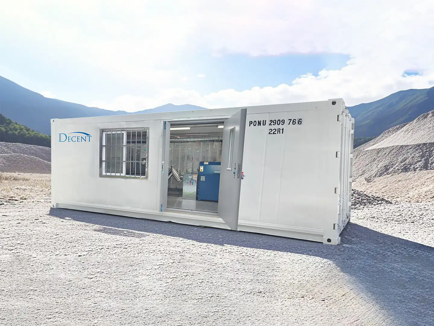 A white mobile containerized laboratory with the DECENT logo, situated in a rugged, mountainous outdoor environment, representing Qingdao Decent Group's turnkey lab solutions.