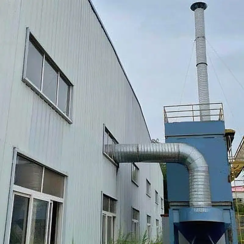 External factory dedusting system by Qingdao Decent Group, with blue unit and large duct connected to a building