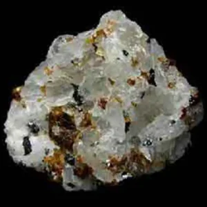 A rough, crystalline specimen of translucent white cryolite, a mineral also known as 'ice stone', with dark reddish and black inclusions.