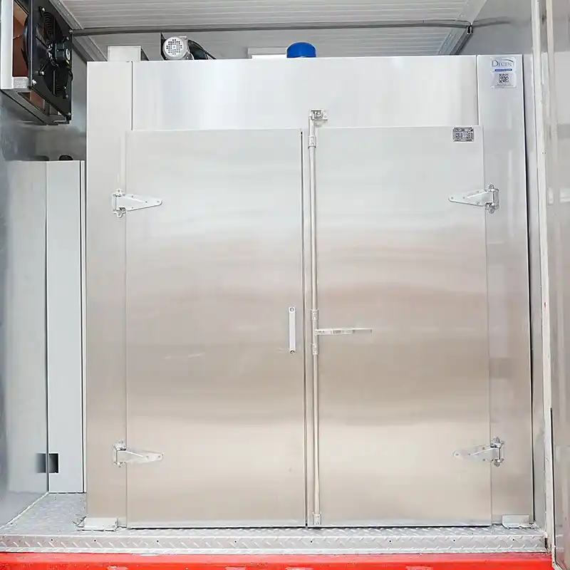 A white DECENT electric drying oven with multiple shelves inside Qingdao Decent Group's containerized laboratory in Côte d'Ivoire.