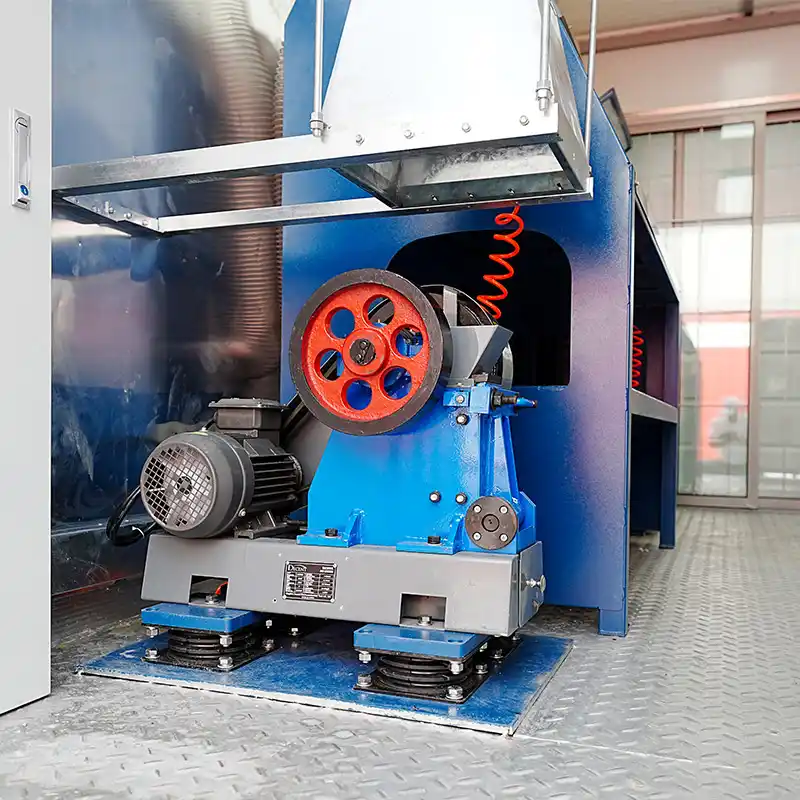 A blue and grey DECENT Jaw Crusher with a red flywheel, installed in the sample preparation area of a containerized laboratory in Djibouti.