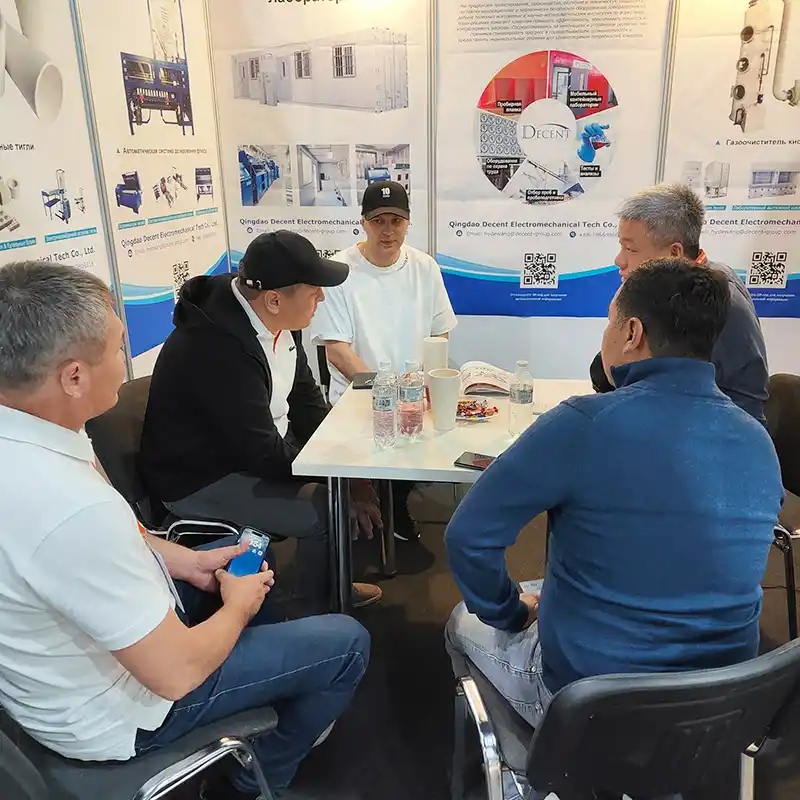 Qingdao Decent Group representatives and attendees in a discussion at the DECENT booth during Mining and Metals Central Asia 2025, showcasing on-site exchanges about mineral processing solutions.