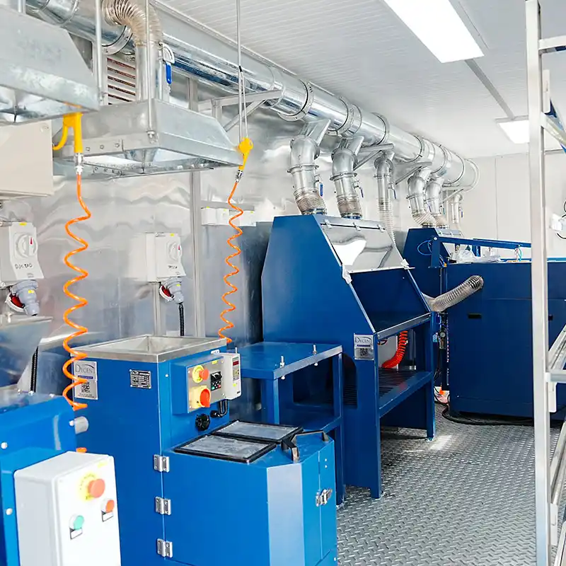 Interior of a DECENT containerized laboratory in Côte d'Ivoire, featuring blue sample preparation equipment, workbenches, and an extensive overhead ventilation system.